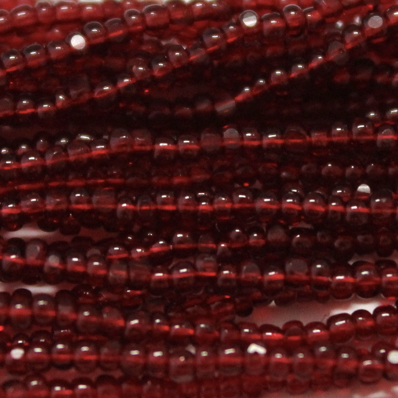 Charlotte Cut Transparent Garnet Glass seed beads
